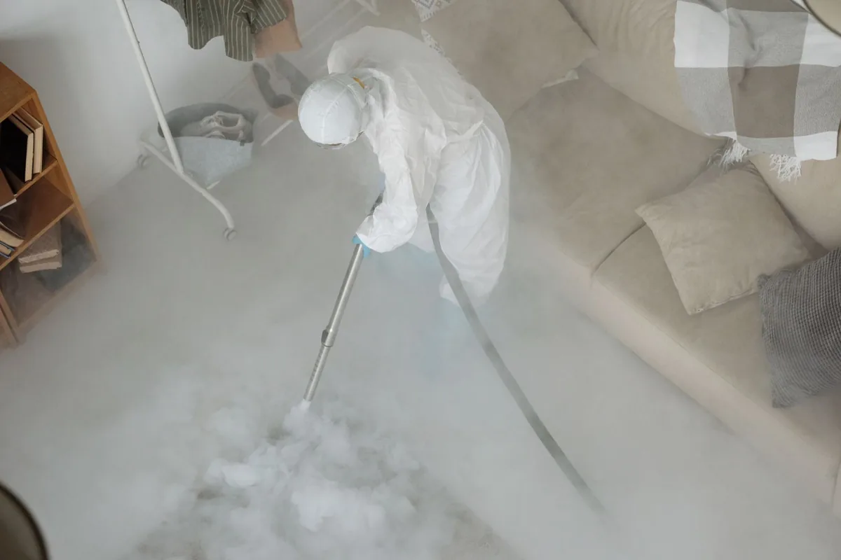 Biohazard cleanup technician in protective equipment, Zellwood, FL